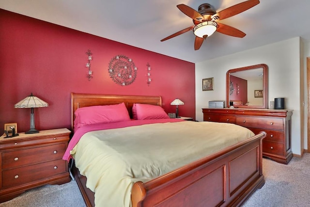 bedroom featuring light carpet and ceiling fan