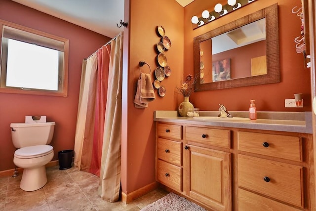 bathroom with vanity, toilet, and tile patterned floors