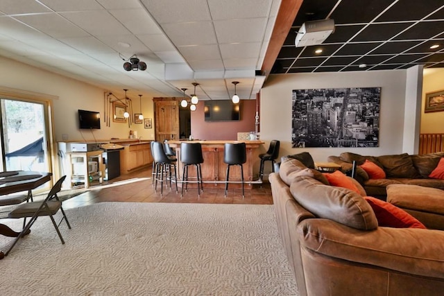 living room with a paneled ceiling