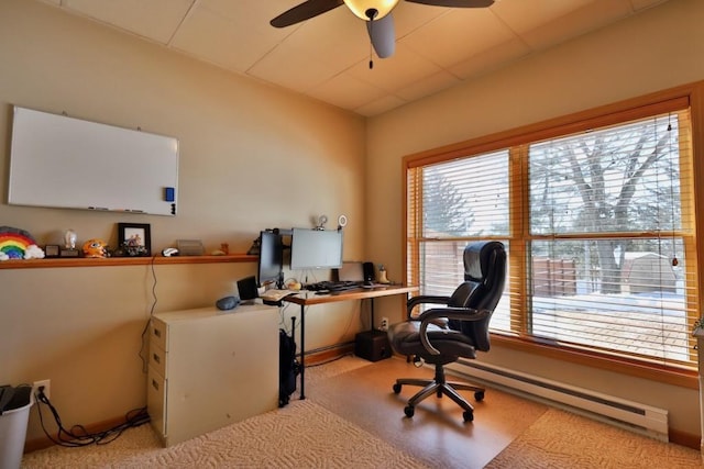 carpeted office featuring baseboard heating and ceiling fan