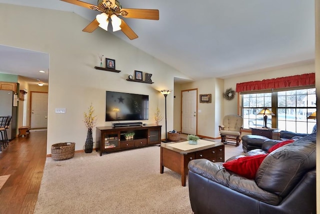 carpeted living room featuring ceiling fan and high vaulted ceiling