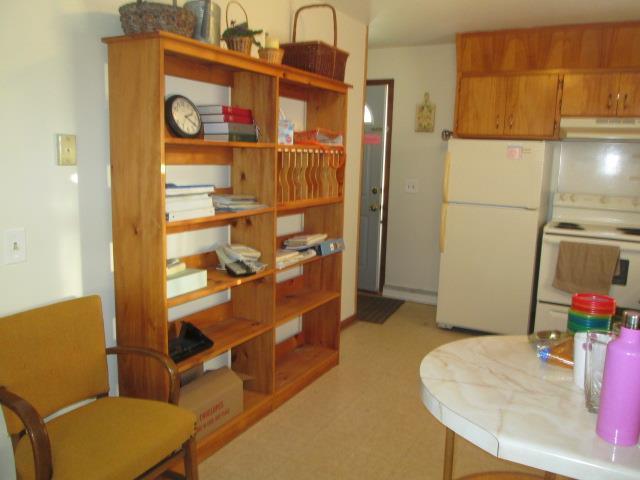 kitchen featuring white appliances and exhaust hood