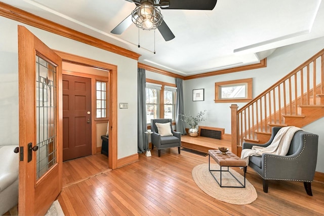 entrance foyer featuring ceiling fan, french doors, crown molding, and wood-type flooring