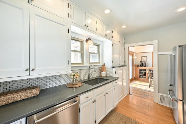 kitchen featuring white cabinetry, appliances with stainless steel finishes, and sink