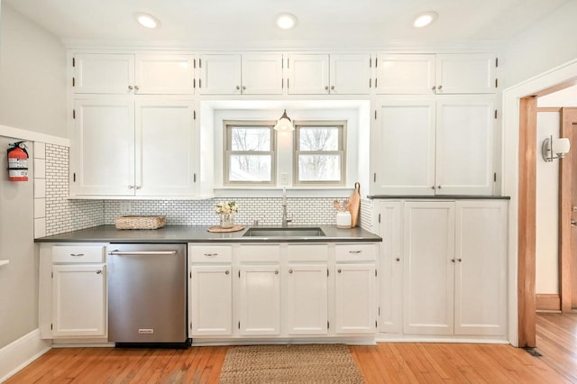 kitchen with sink, white cabinetry, and dishwasher