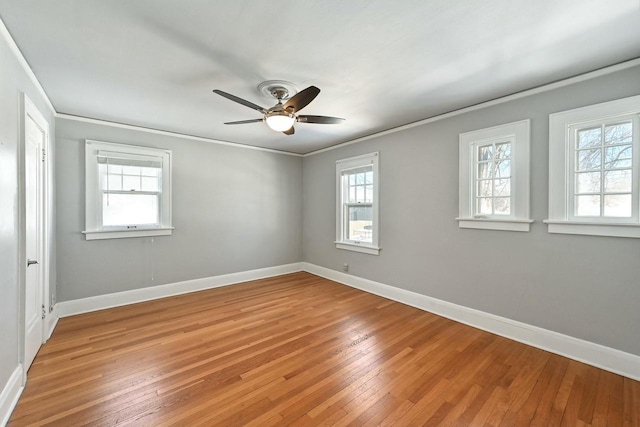 spare room featuring ceiling fan, light wood-type flooring, and crown molding