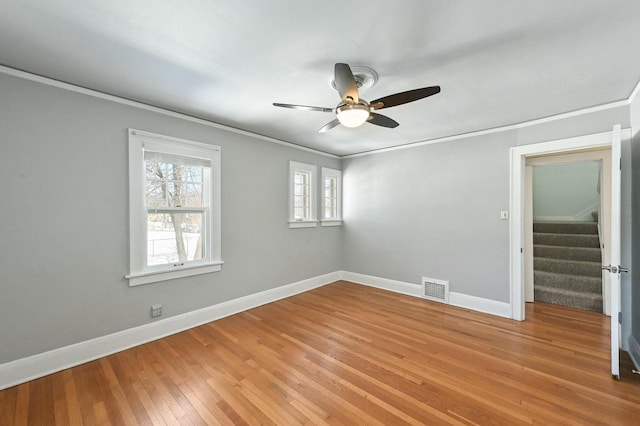 unfurnished room featuring ceiling fan, ornamental molding, and light hardwood / wood-style floors