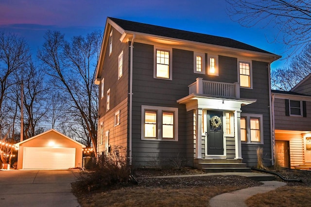 view of front of house featuring a garage, a balcony, and an outdoor structure