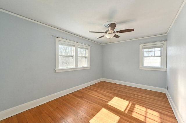 spare room with ceiling fan, plenty of natural light, crown molding, and light hardwood / wood-style flooring