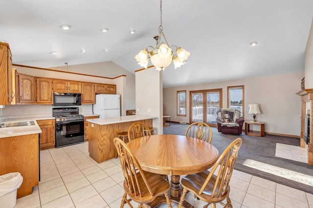 tiled dining space with vaulted ceiling, sink, and a notable chandelier