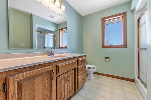 bathroom featuring toilet, vanity, and walk in shower