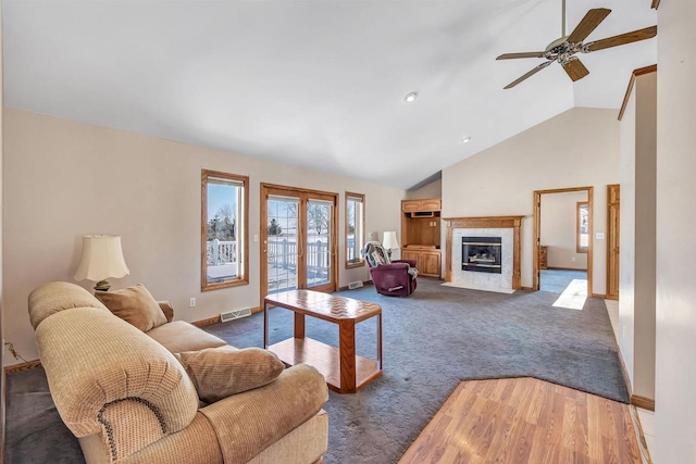 carpeted living room with a fireplace, ceiling fan, french doors, and lofted ceiling