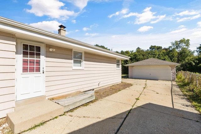 view of home's exterior featuring an outdoor structure and a garage