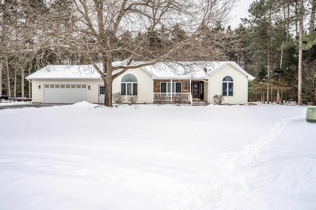 single story home featuring covered porch and a garage