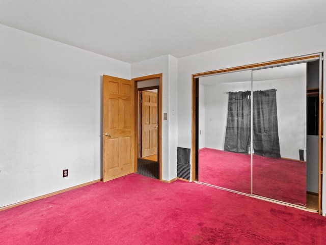 unfurnished bedroom with carpet and a closet