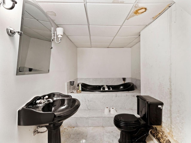 bathroom featuring a paneled ceiling and toilet