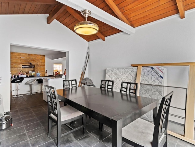 dining area with wooden ceiling and vaulted ceiling with beams