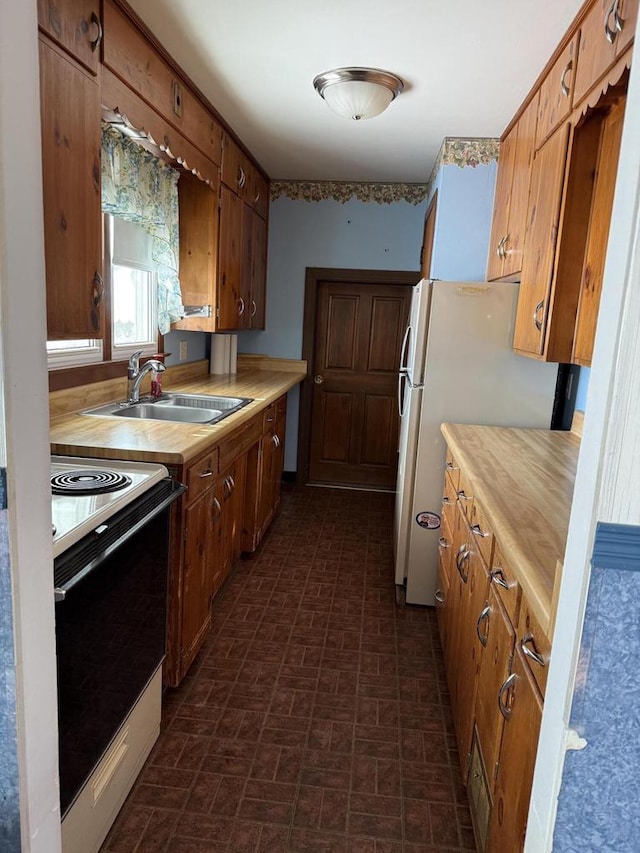 kitchen with sink, fridge, and white electric stove