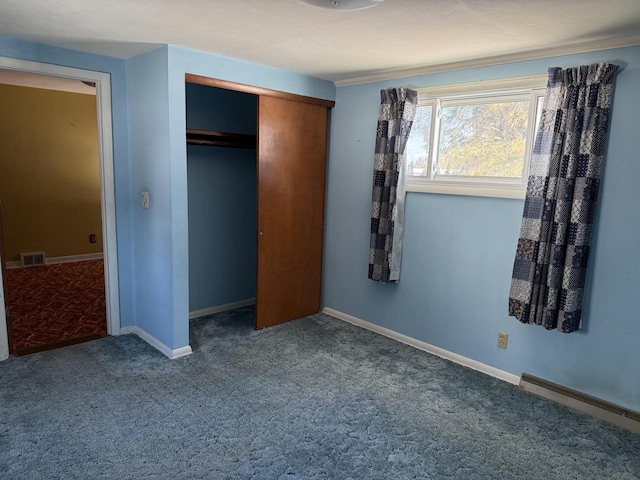 unfurnished bedroom featuring a closet and carpet flooring