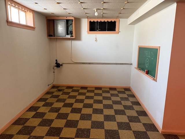 basement featuring a paneled ceiling