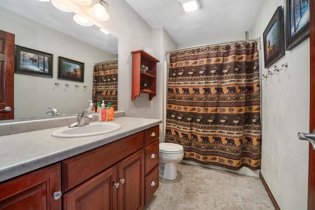 bathroom with a shower with shower curtain, vanity, tile patterned flooring, and toilet