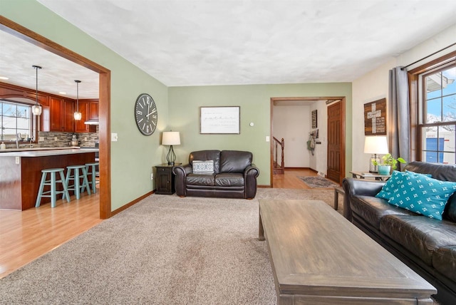 living room with light carpet, a wealth of natural light, and sink