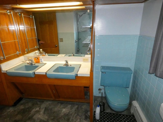 bathroom with a baseboard heating unit, toilet, tile walls, and vanity