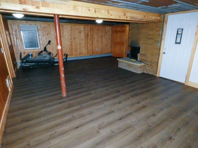 620 S Buchanan St, Prairie Du Chien, WI 53821 - finished basement with dark wood-style flooring, a wood stove, and wooden walls