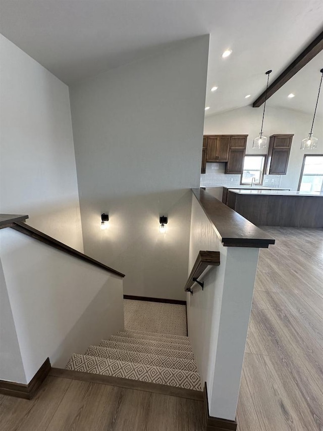 stairs featuring vaulted ceiling with beams, wood finished floors, recessed lighting, and baseboards