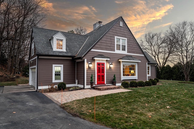 view of front facade with a garage and a lawn