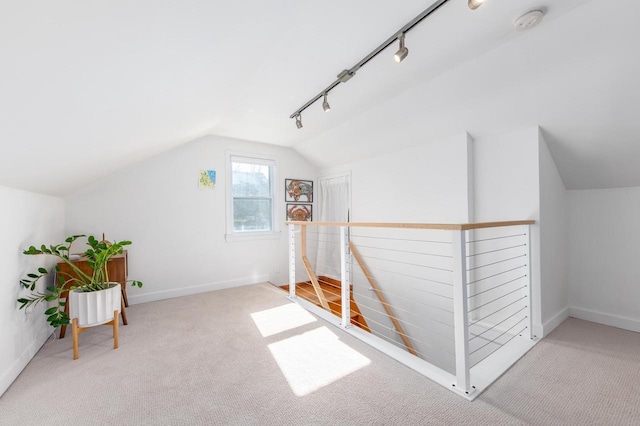 bonus room featuring vaulted ceiling and light colored carpet