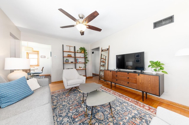 living room with ceiling fan and wood-type flooring