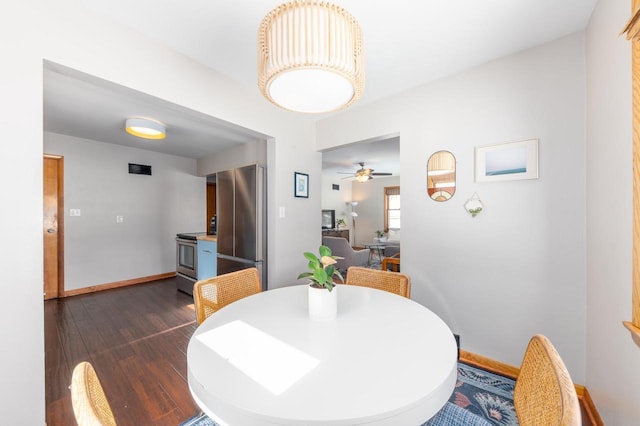 dining room featuring ceiling fan and dark wood-type flooring