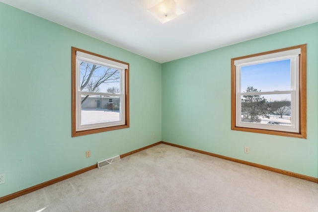 unfurnished room with light colored carpet