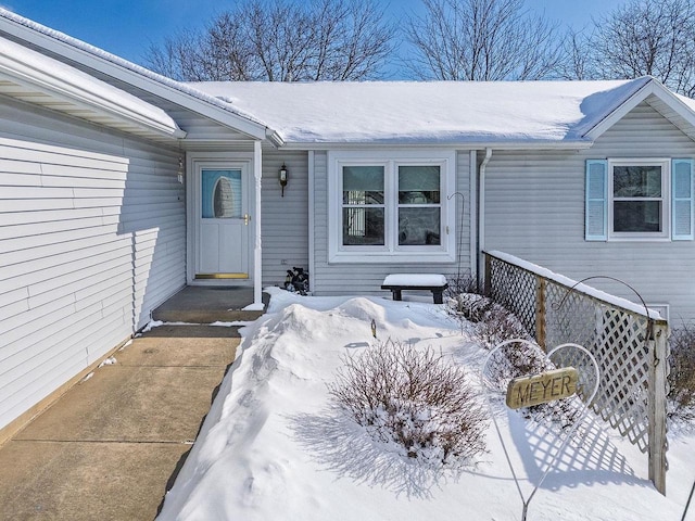 view of snow covered property entrance