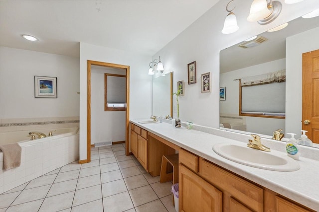 bathroom featuring vanity, tile patterned flooring, and a relaxing tiled tub