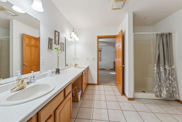 bathroom featuring tile patterned flooring, vanity, and walk in shower