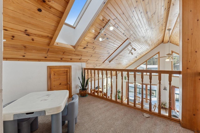 additional living space featuring a wealth of natural light, wood ceiling, a skylight, and carpet floors