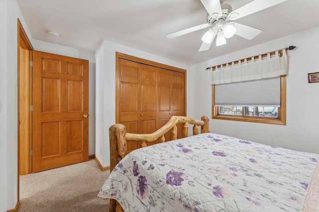 bedroom with a closet, light colored carpet, and ceiling fan