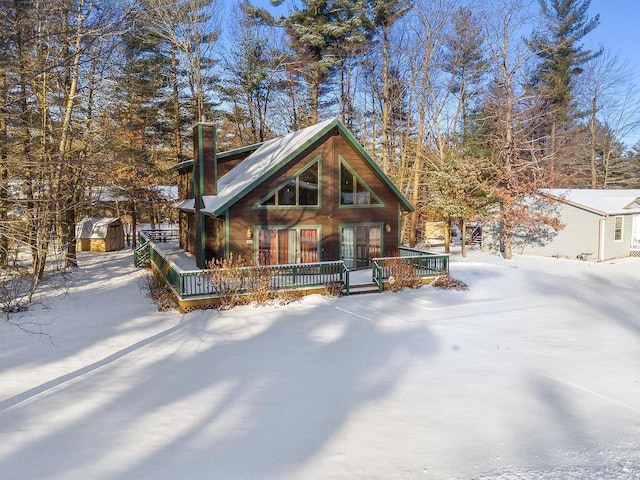 view of front of house with a storage unit and a wooden deck