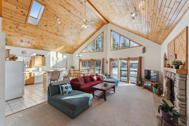 living room with a healthy amount of sunlight, wood ceiling, light colored carpet, and a stone fireplace