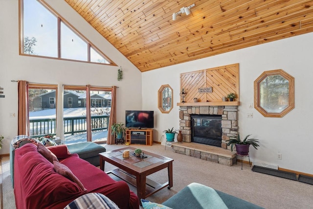 carpeted living room with high vaulted ceiling, a stone fireplace, and wooden ceiling