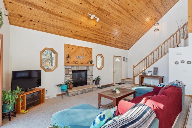 carpeted living room featuring high vaulted ceiling, wood ceiling, and a stone fireplace