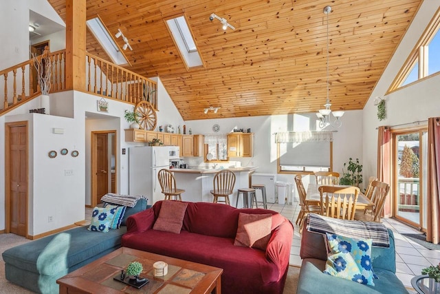 living room featuring plenty of natural light, light tile patterned flooring, wood ceiling, and a skylight