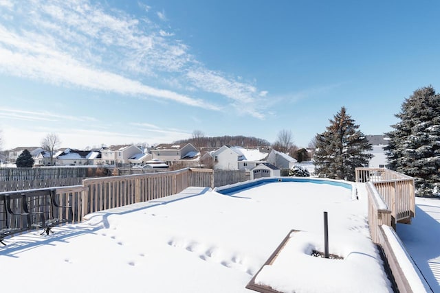 yard layered in snow with a wooden deck