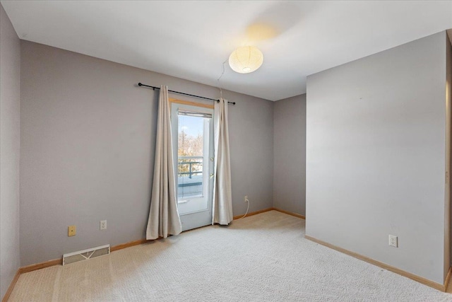 spare room with light colored carpet