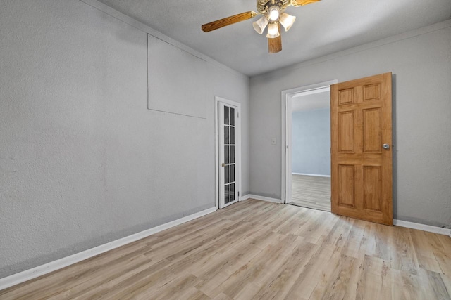 empty room featuring ceiling fan and light hardwood / wood-style flooring