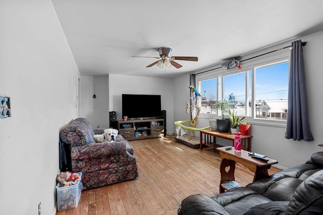 living room featuring ceiling fan and wood-type flooring