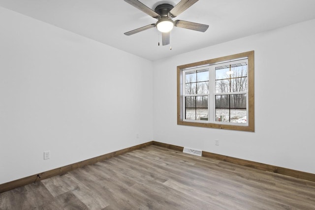 empty room featuring hardwood / wood-style flooring and ceiling fan