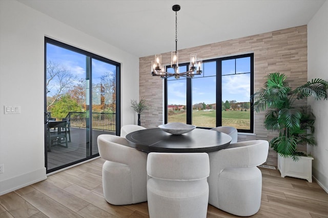 dining room featuring light hardwood / wood-style floors, a chandelier, and a wealth of natural light